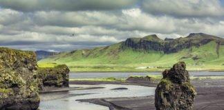 The black sand beach with typical Icelandic mountain landscapes